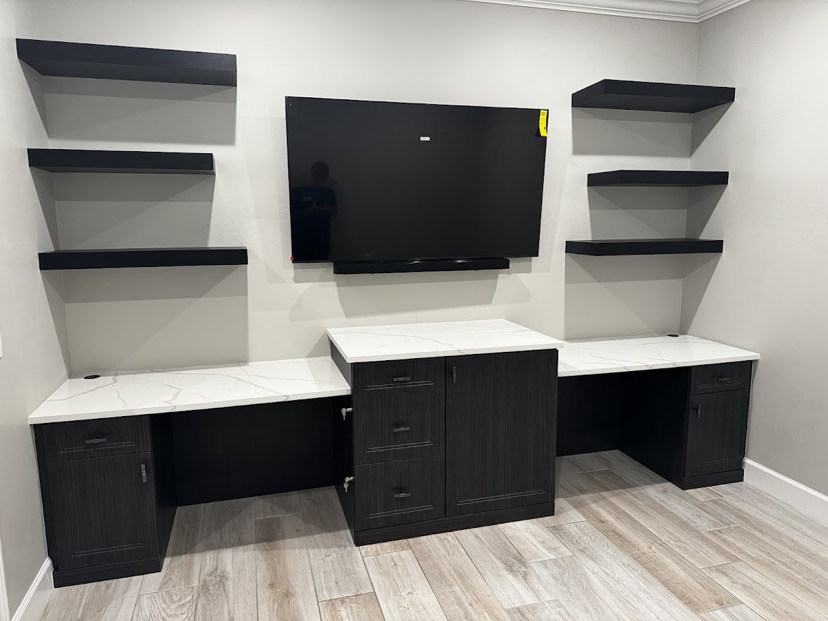 Custom dark wood dual desk home office with floating shelves and built-in storage in Bradenton FL