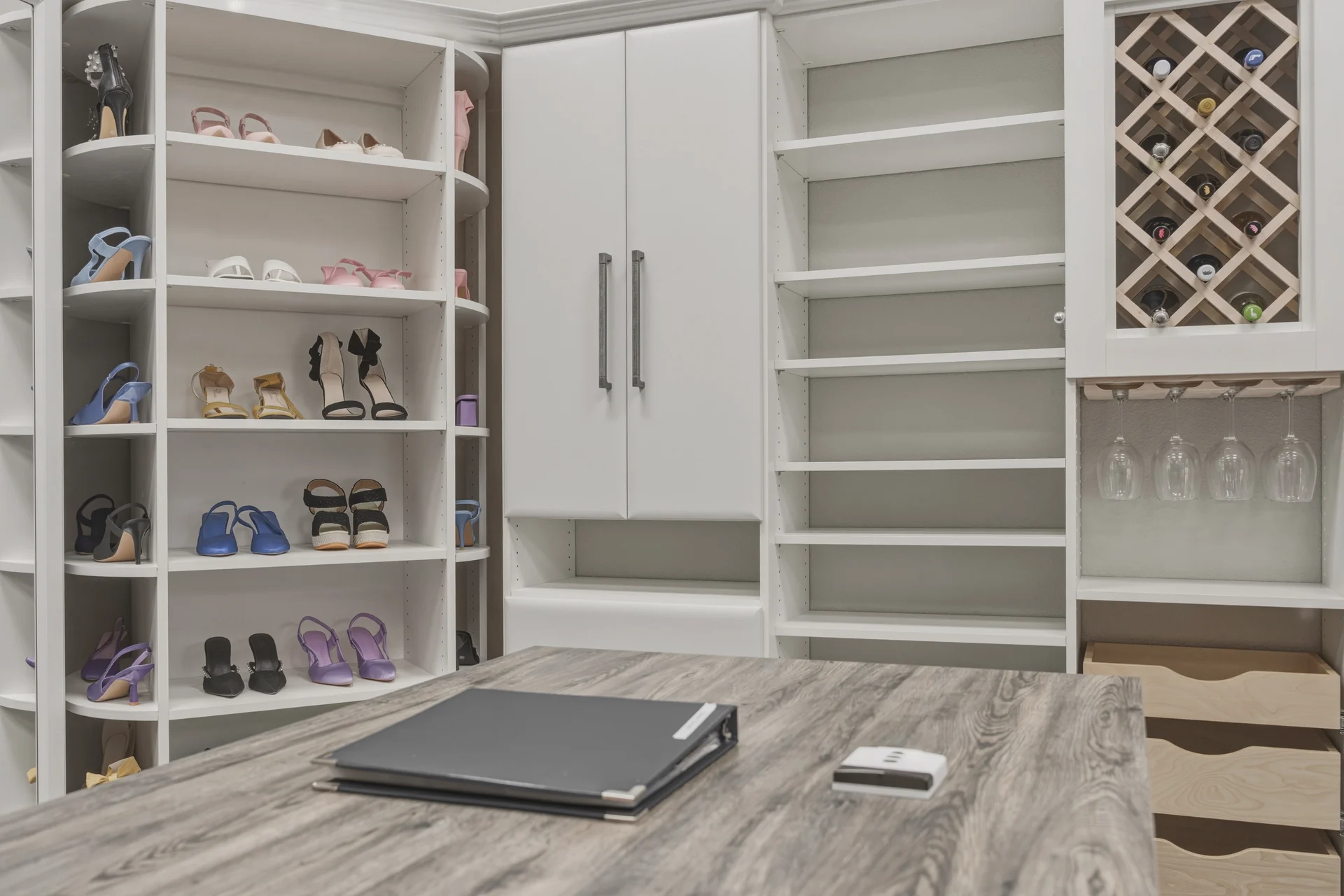 Dream Closets LLC showroom closet with center island, open shelving, and wine rack in Bradenton FL