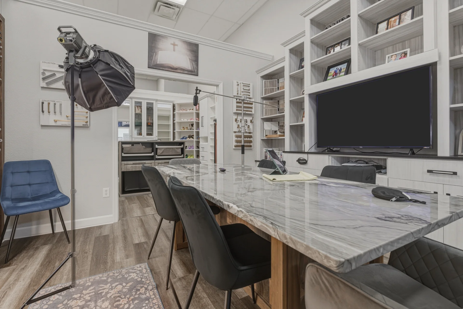 Dream Closets LLC showroom consultation room with marble table and custom built-in displays in Bradenton FL