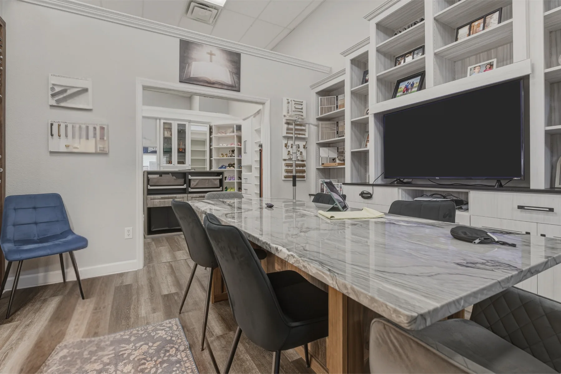 Dream Closets LLC showroom consultation room with marble table and custom built-in displays in Bradenton FL