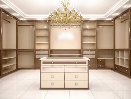Luxury custom walk-in closet with chandelier by Dream Closets LLC