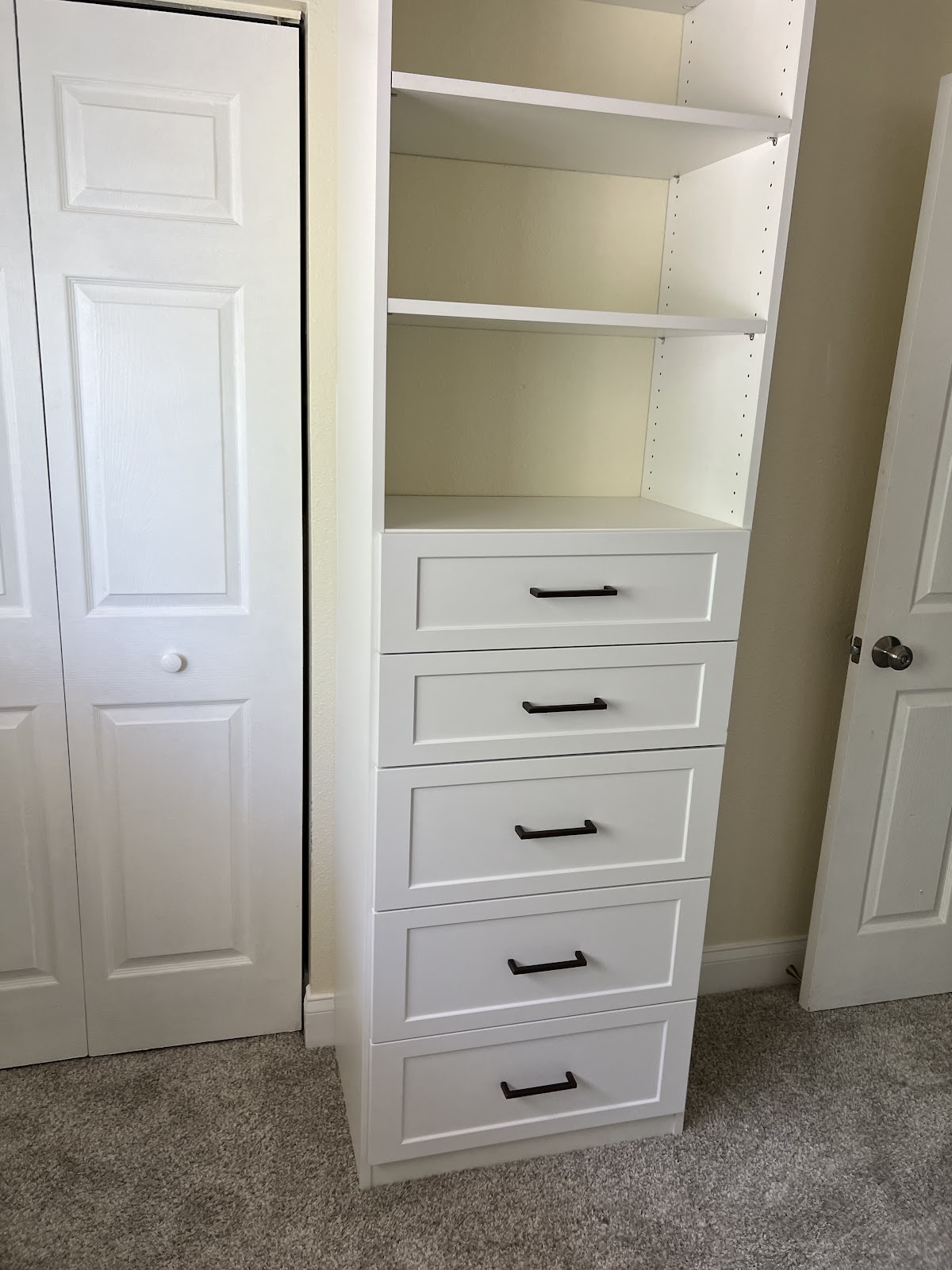Custom reach-in closet with shaker drawer tower and matte black hardware in Lakewood Ranch FL by Dream Closets LLC